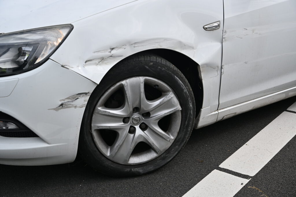 Auto tussen vangrail gedrukt door bedrijfsbusje [FOTO'S]